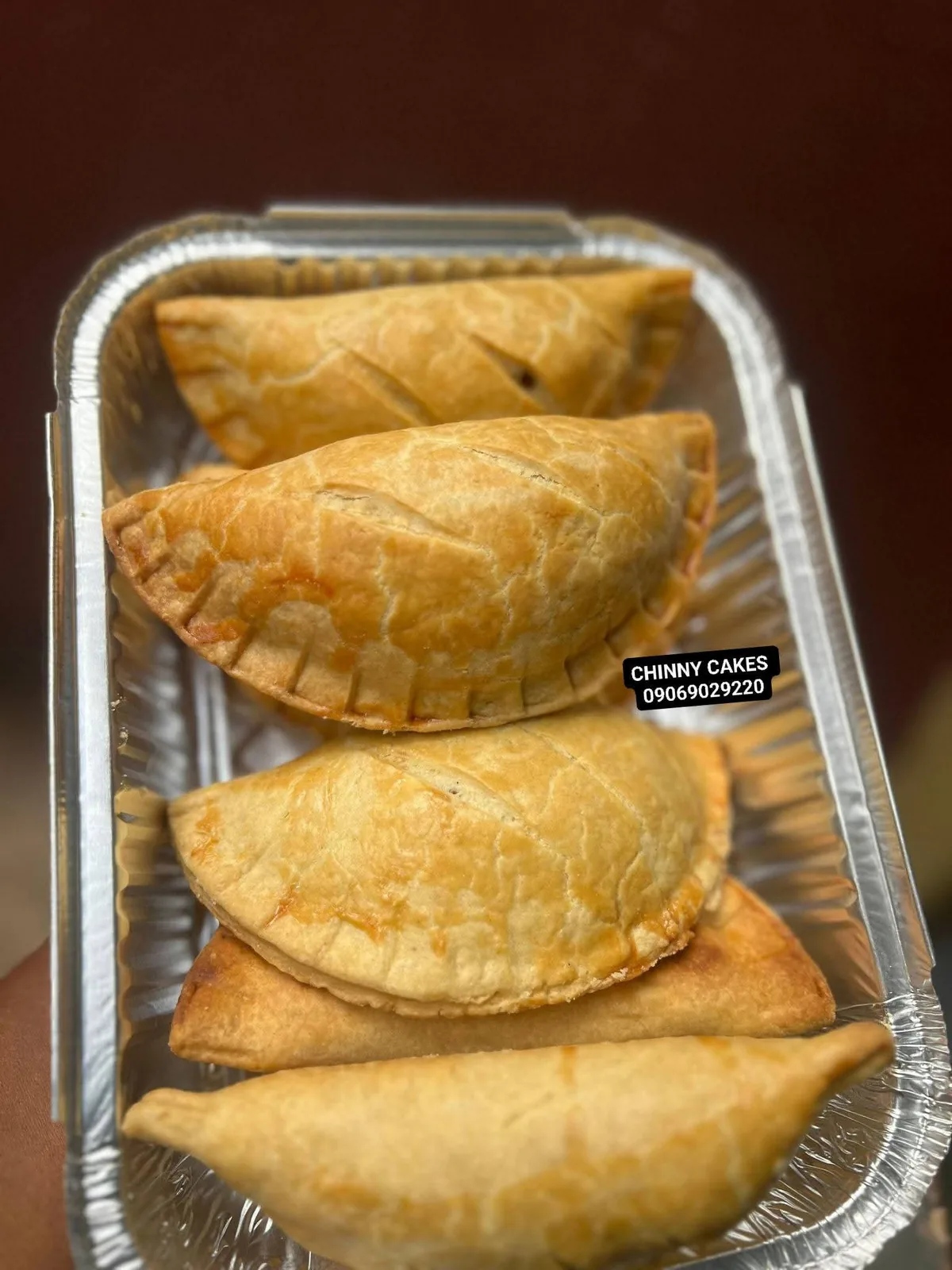 Golden baked pastries arranged in a foil tray